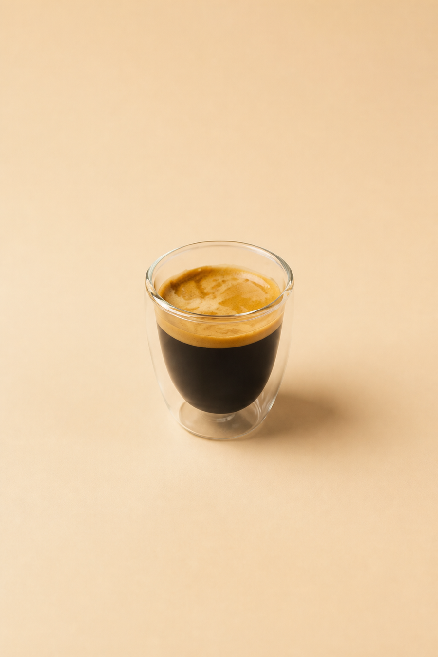 Espresso on a warm cream studio background